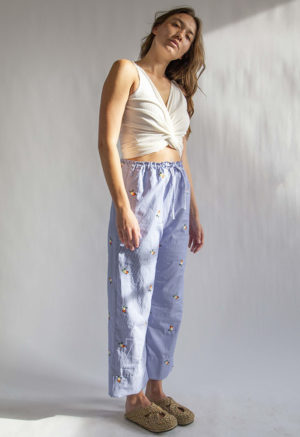 Front/side view of straight size model wearing Embroidered Blue Stripe Limited Run Drawstring Wide-Leg Pant.