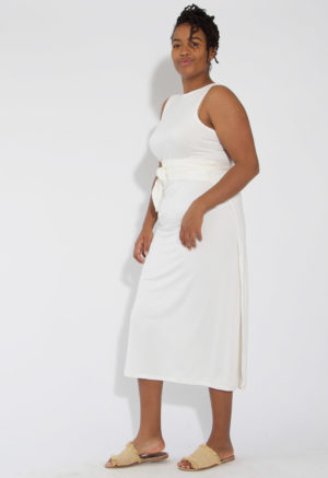 Front/side view of straight size model wearing White Sleeveless Wrap Dress.