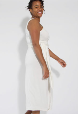 Side view of straight size model wearing White Sleeveless Wrap Dress.
