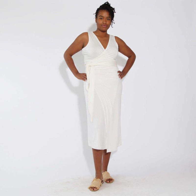 Front view of straight size model wearing White Sleeveless Wrap Dress.