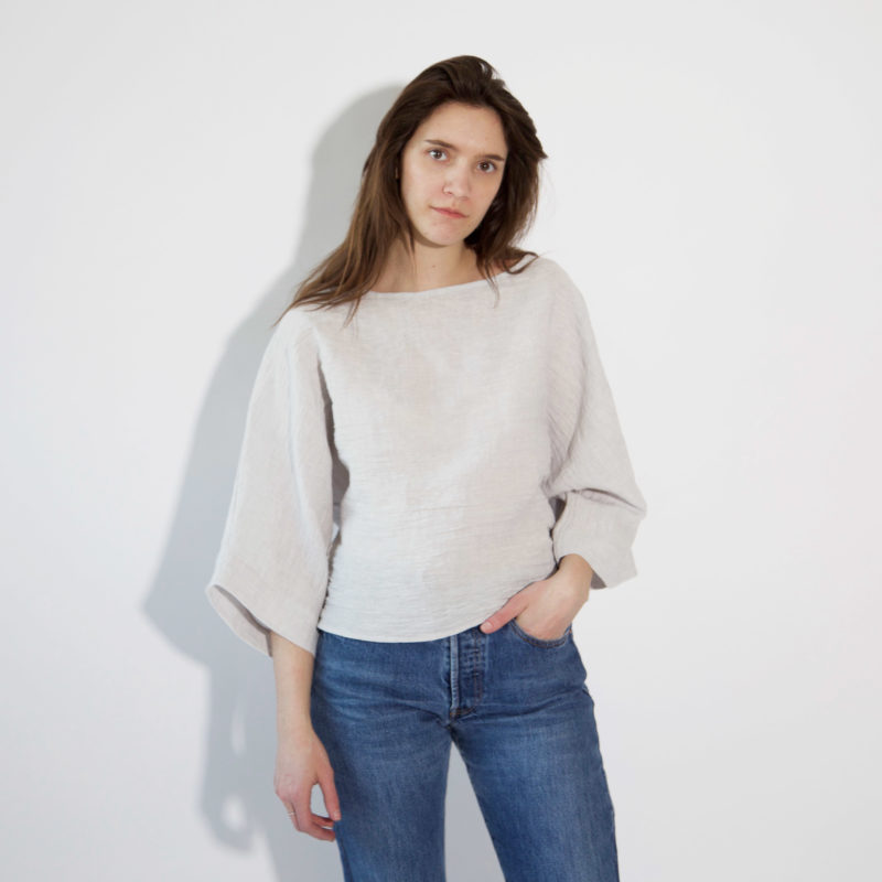 Front view of straight size model wearing Light Gray Dolman Tee.