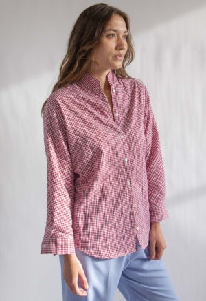 Front/side view of straight size model wearing Burgundy Gingham Limited Edition Long Sleeve Dolman Button-Up Top.