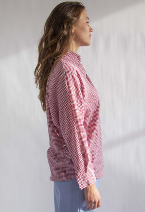 Side view of straight size model wearing Burgundy Gingham Limited Edition Long Sleeve Dolman Button-Up Top.