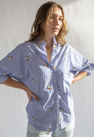 Front view of straight size model wearing Embroidered Blue Stripe Limited Run Long Sleeve Dolman Button-Up Top.
