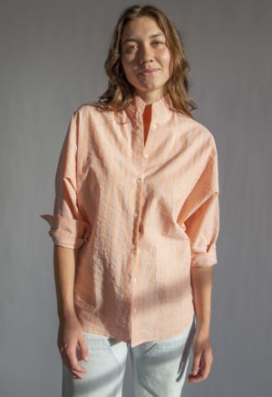 Front view of straight size model wearing Peach Stripe Limited Edition Long Sleeve Dolman Button-Up Top.