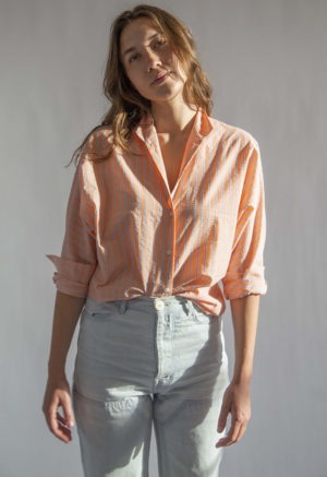 Front view of straight size model wearing Peach Stripe Limited Edition Long Sleeve Dolman Button-Up Top.