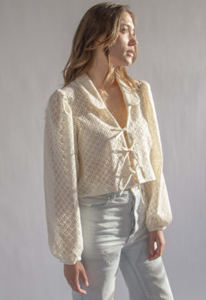 Front/side view of straight size model wearing Cream Eyelet Limited Edition Beverly Top.