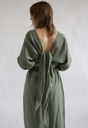 Back view of straight size model wearing Moss Linen Long Sleeve Tie Top.