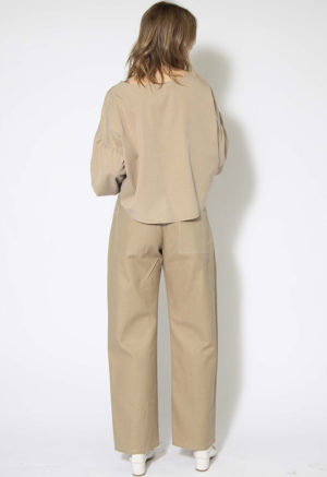 Back view of straight size model wearing Latte Lyocell Boatneck Cropped Balloon Sleeve Top.
