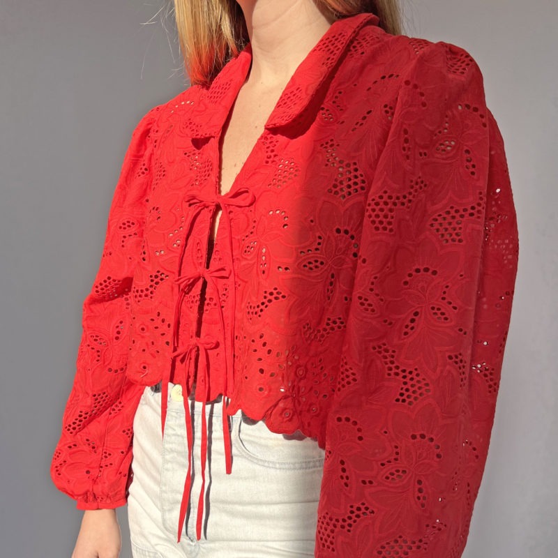 Front/side view of straight size model wearing Red Eyelet Limited Edition Ramona Top.