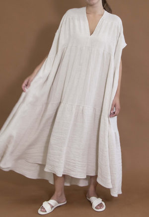 woman in oatmeal linen v-neck tiered maxi dress