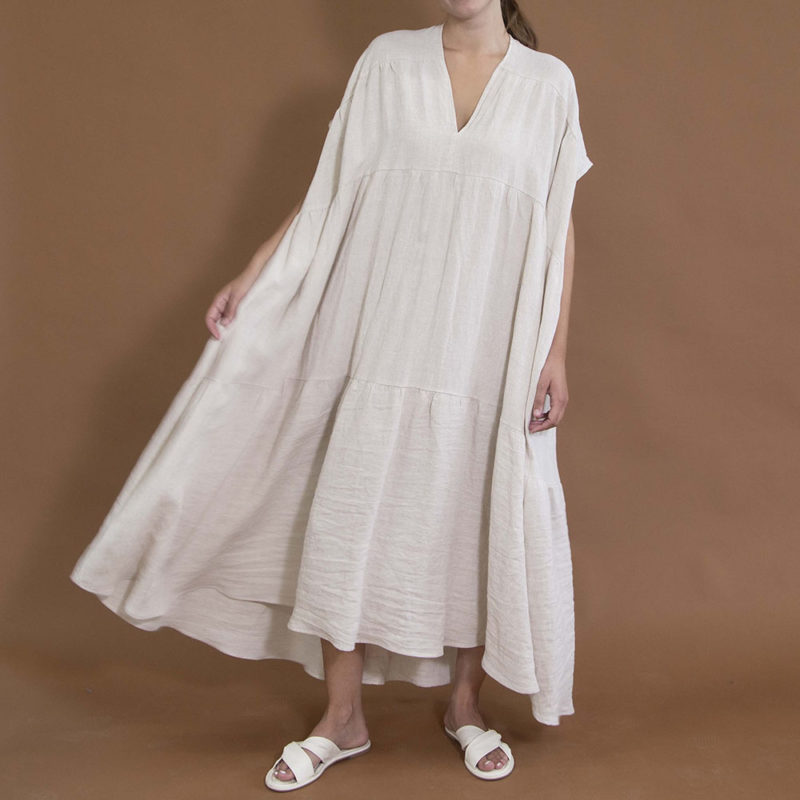 woman in oatmeal linen v-neck tiered maxi dress