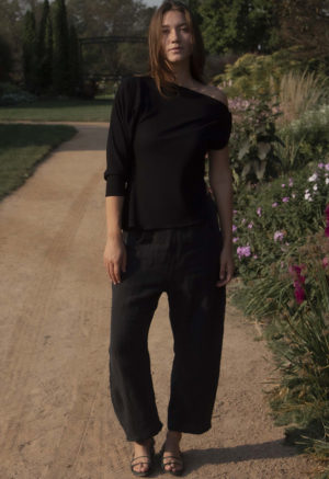 woman wearing off the shoulder black rib top and black matching pants