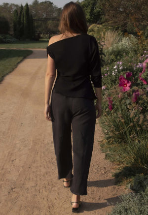 woman wearing off the shoulder black rib top and black matching pants