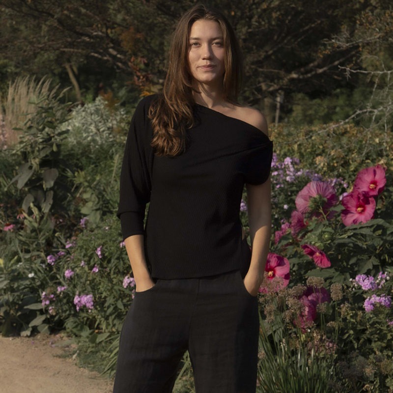 woman wearing off the shoulder black rib top and black matching pants