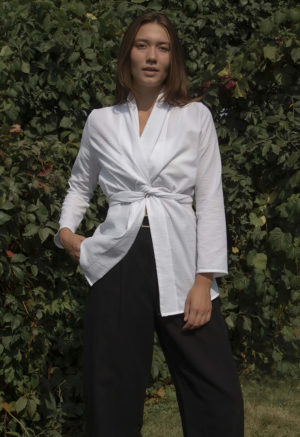 woman in wrap blazer and black trousers