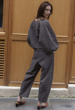 woman wearing dark grey balloon sleeve top and matching barrel leg pants