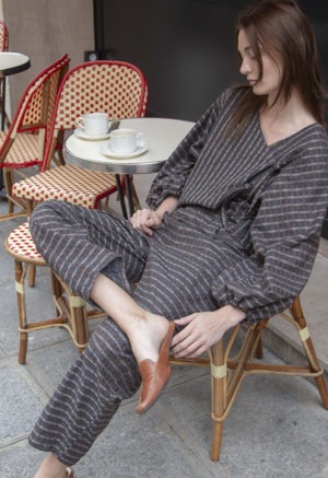 woman wearing dark grey balloon sleeve top and matching barrel leg pants