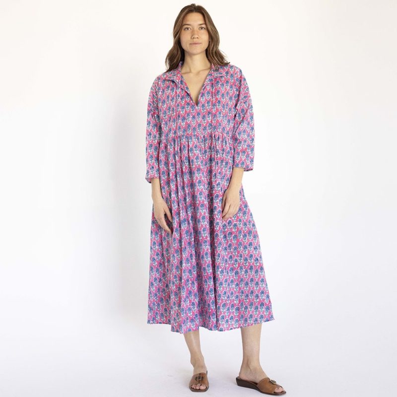 women wearing pink floral oversized dress with dolman sleeves, collar and ties at neck