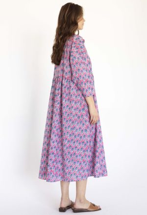 women wearing pink floral oversized dress with dolman sleeves, collar and ties at neck