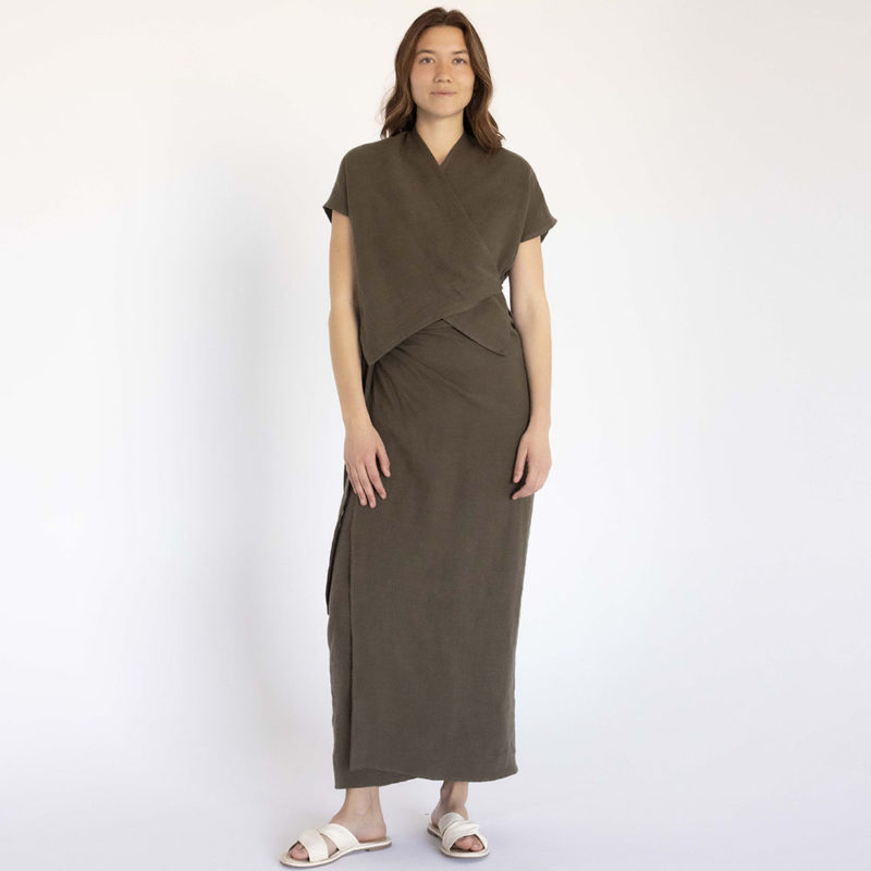 woman in dark green short sleeve cropped wrap top and matching maxi wrap skirt