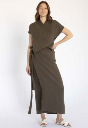 woman in dark green short sleeve cropped wrap top and matching maxi wrap skirt
