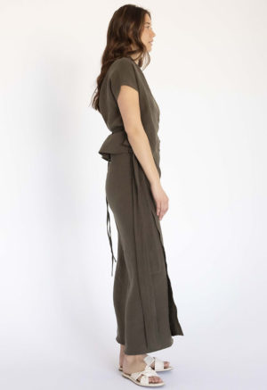 woman in dark green short sleeve cropped wrap top and matching maxi wrap skirt