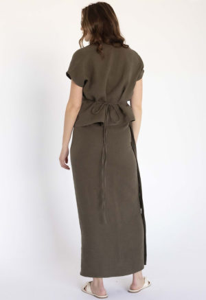 woman in dark green short sleeve cropped wrap top and matching maxi wrap skirt