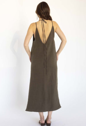 woman in dark green linen v-neck maxi swing dress