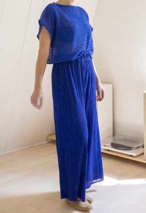 woman in royal blue pleated wide-leg pants and royal blue knit short sleeve top