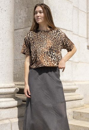 woman in leopard print cropped t-shirt and dark green skirt