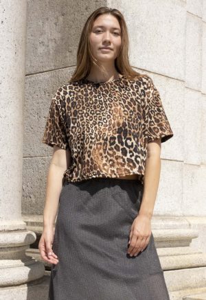 woman in leopard print cropped t-shirt and dark green skirt