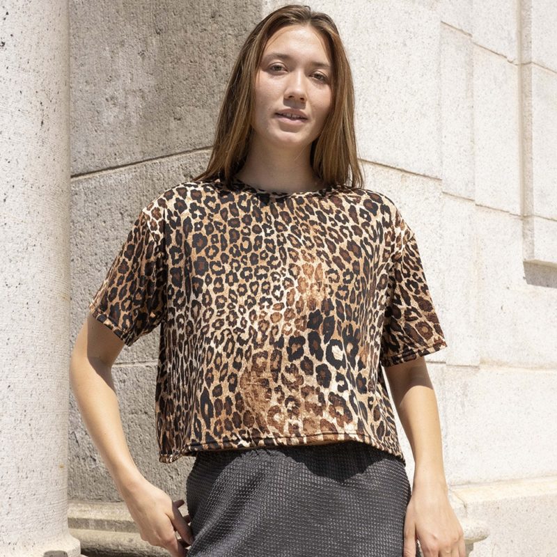 woman in leopard print cropped t-shirt and dark green skirt