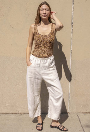 woman in leopard print scoop tank and white low rise baggy pants