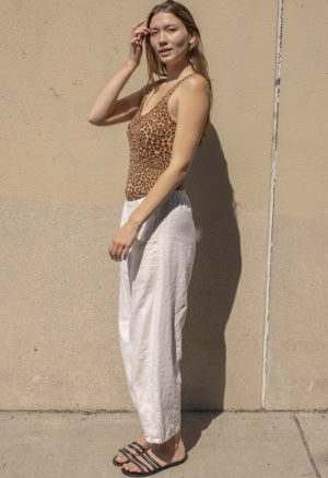 woman in leopard print scoop tank and white low rise baggy pants