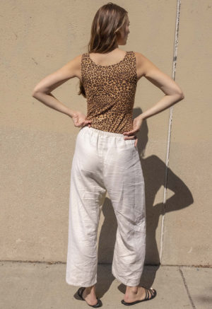 woman in leopard print scoop tank and white low rise baggy pants