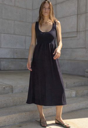 woman in black scoop neck midi tank dress and green sandals