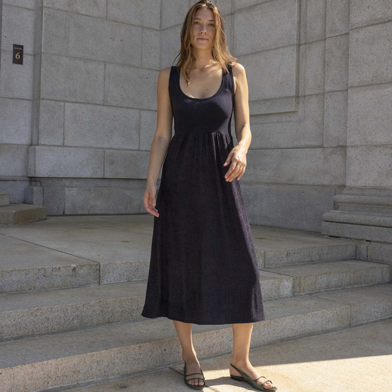 woman in black scoop neck midi tank dress and green sandals