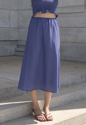 woman in hazy blue slip skirt and matching tube top
