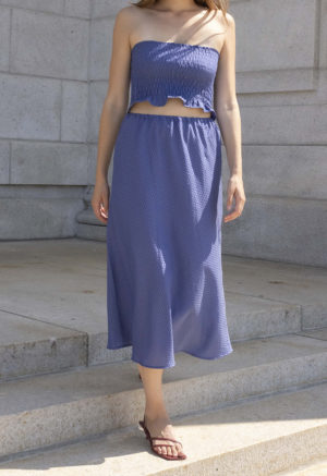 woman in hazy blue slip skirt and matching tube top