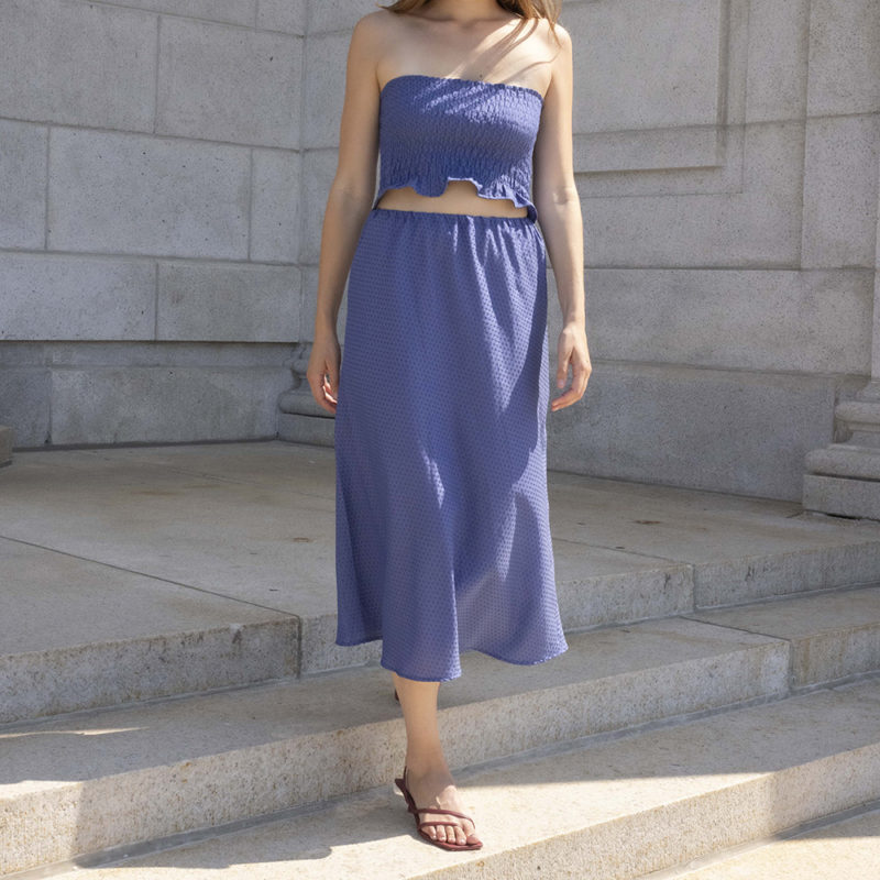 woman in hazy blue slip skirt and matching tube top