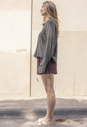 woman in dark chocolate brown shorts and black and white button-up shirt