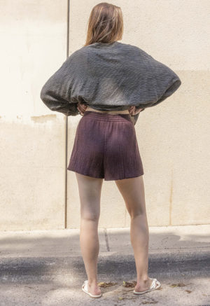 woman in dark chocolate brown shorts and black and white button-up shirt
