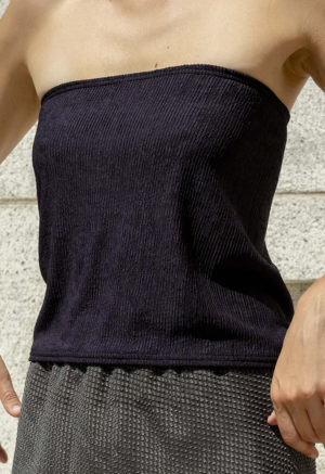 woman in black tube top and green sheer slip skirt