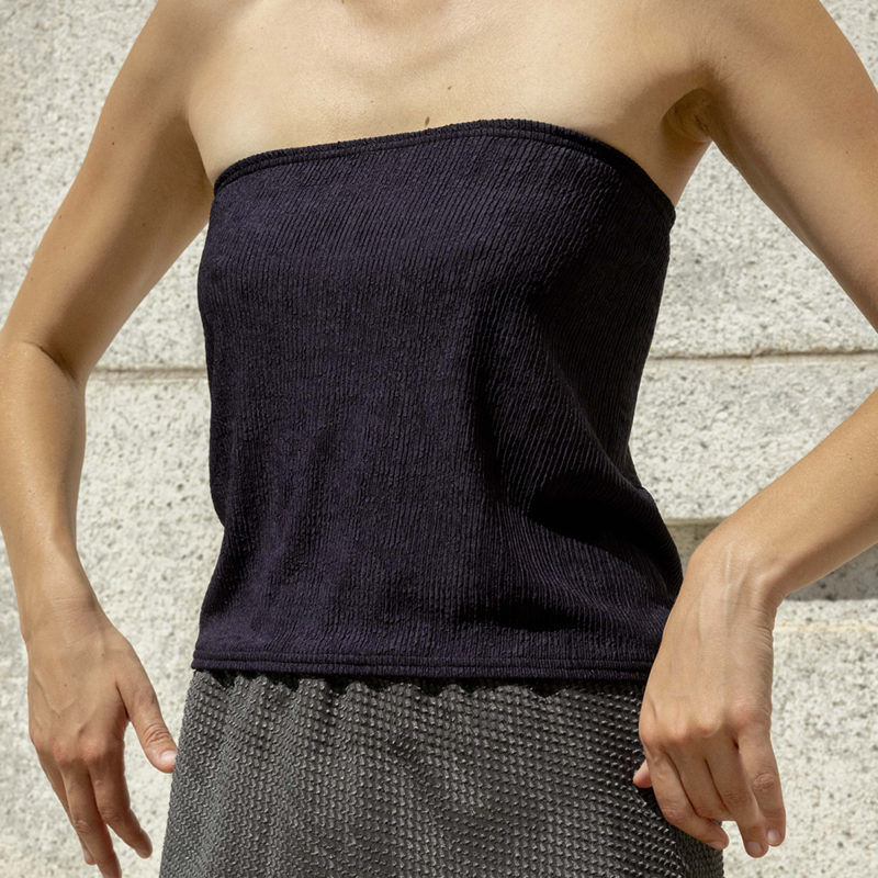 woman in black tube top and green sheer slip skirt