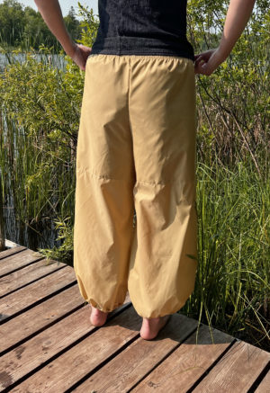 woman in tan/yellow wide-leg pant with balloon cuff