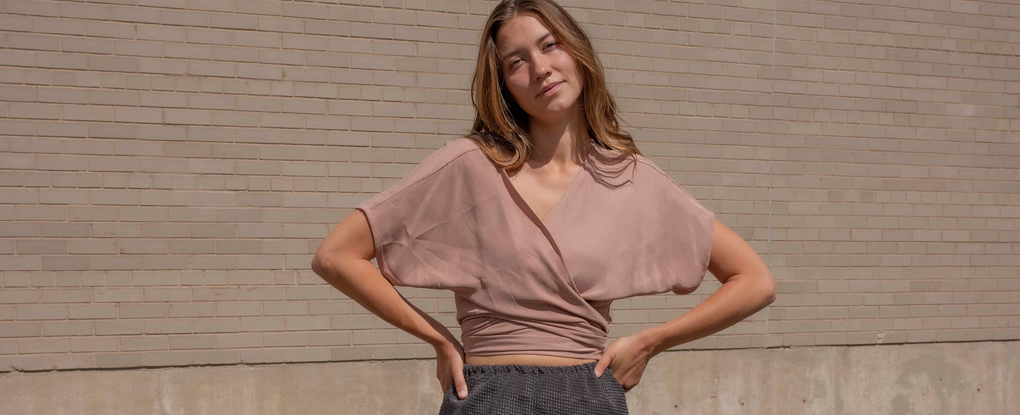 woman in blush short sleeve wrap top