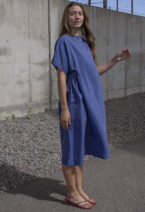 woman in blue boatneck midi length dress