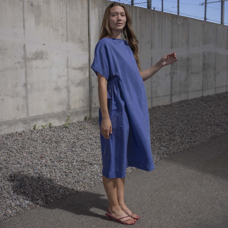woman in blue boatneck midi length dress