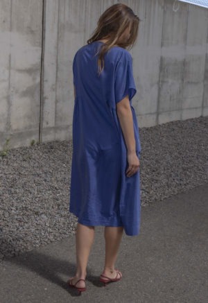 woman in blue boatneck midi length dress